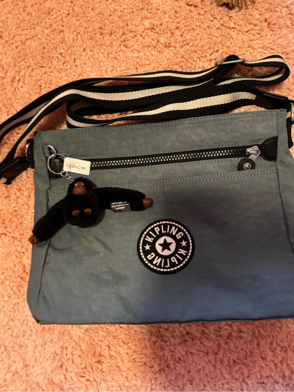 Kipling Slate Blue Crossbody Bag with Striped Strap and Monkey Keychain